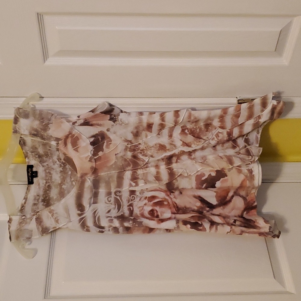 Small sleeveless top with ruffles down front
